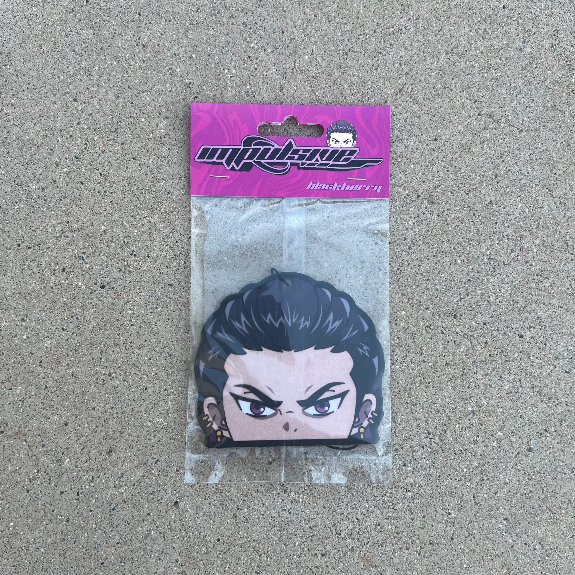 Anime Reyna Anime Character Air Freshener. Purple slick back hair with purple eyes and gold cuff earrings. Angry japanese air freshener hanging from black string. Purple swirl background with impulsive llc retro y2k logo and blackberry label cardboard head card packaging.