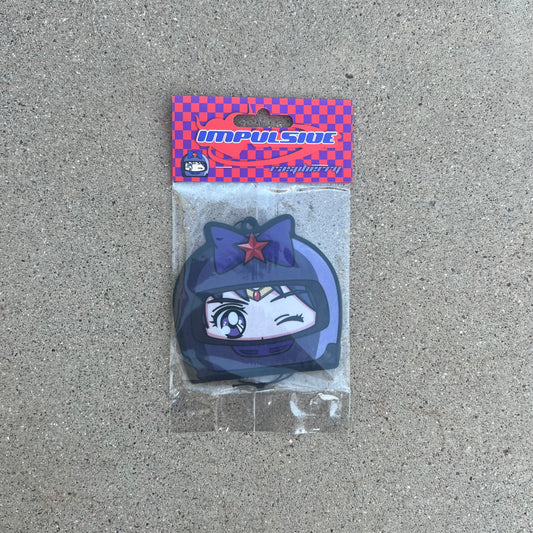 Mars air freshener. Purple helmet with purple bow and red star on purple eyes japanese anime girl hanging from black string. purple and red checkered background with purple and red y2k impulsive logo and raspberry label cardboard head card packaging.