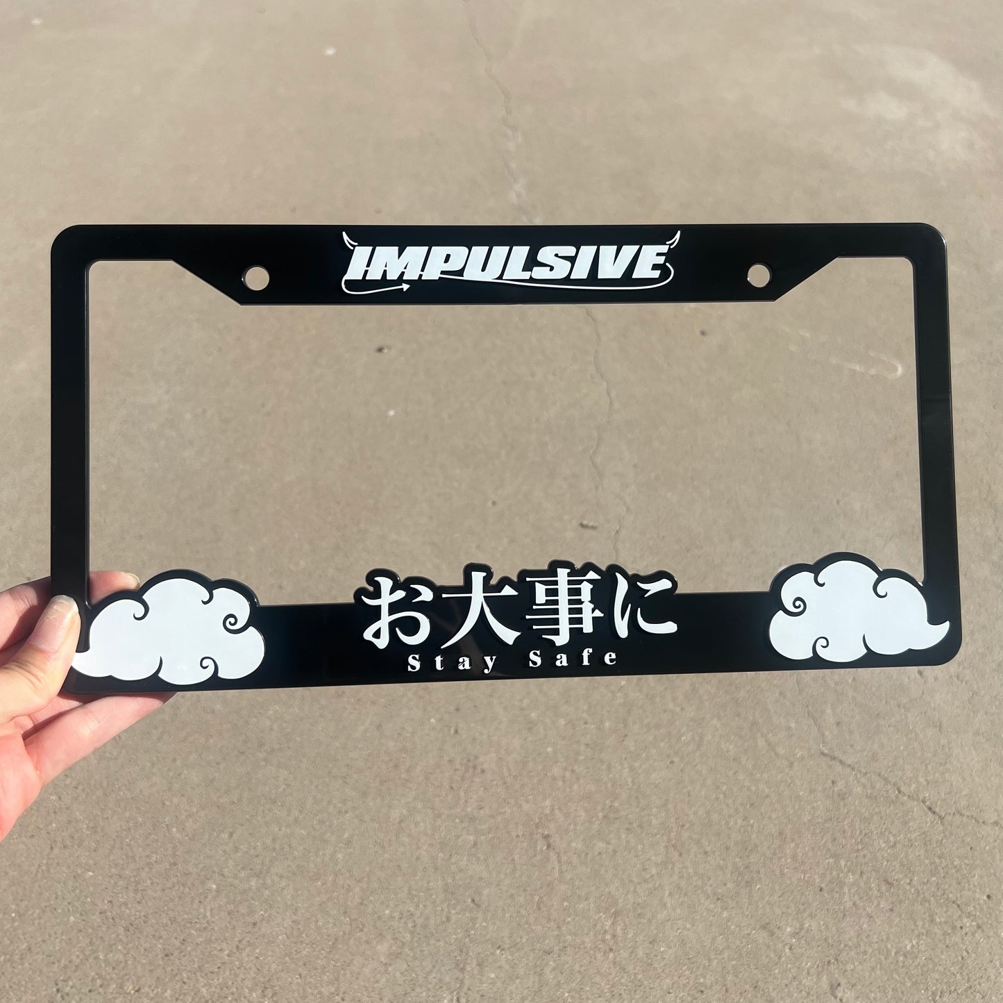 Multiple Japanese anime inspired plastic custom License Plate Frame. Top has Impulsive logo and the bottom has japanese characters and english translated to stay safe surrounding with japanese clouds. Asian inspired. Black Frame with White lettering.