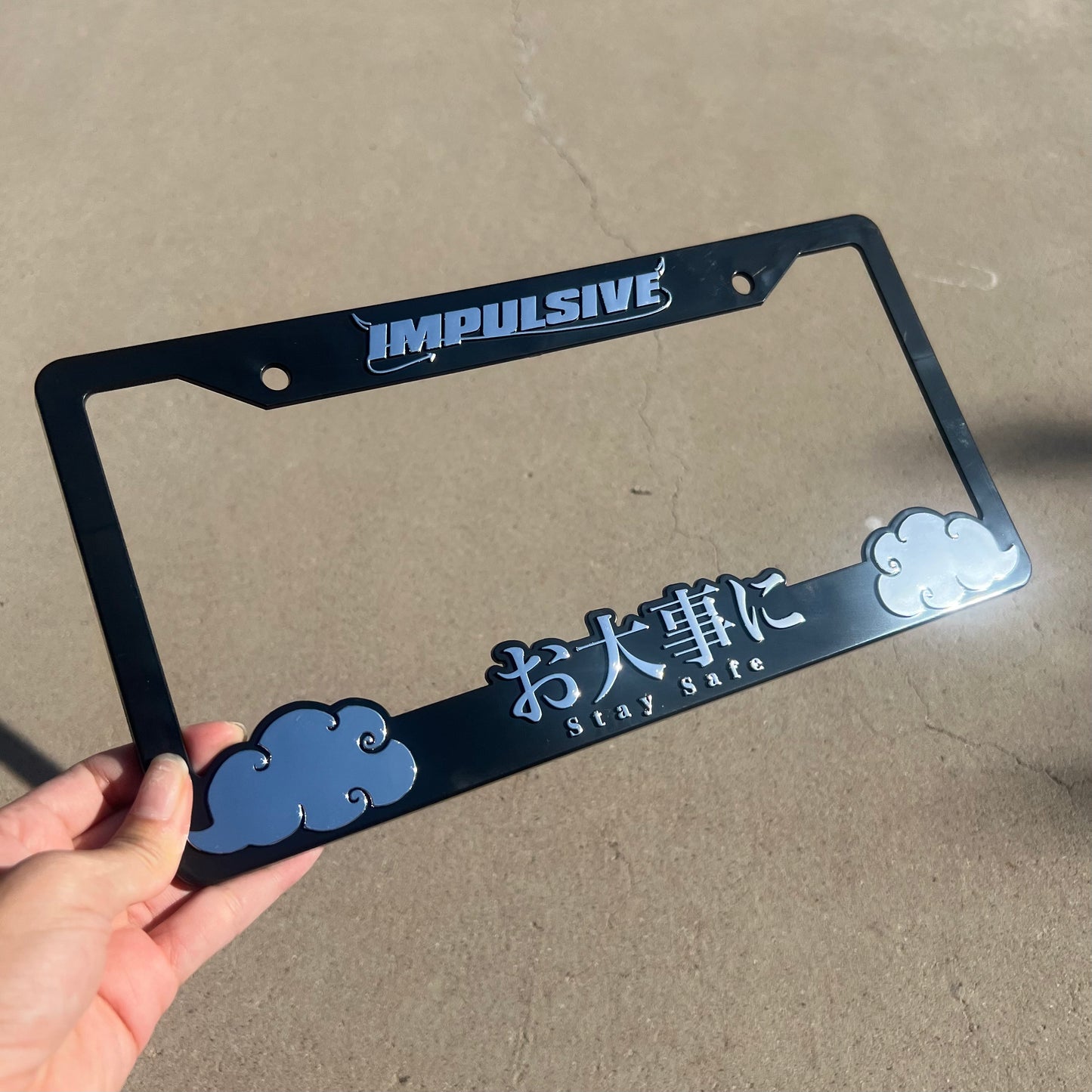 Multiple Japanese anime inspired plastic custom License Plate Frame. Top has Impulsive logo and the bottom has japanese characters and english translated to stay safe surrounding with japanese clouds. Asian inspired. Black Frame with Chrome lettering.