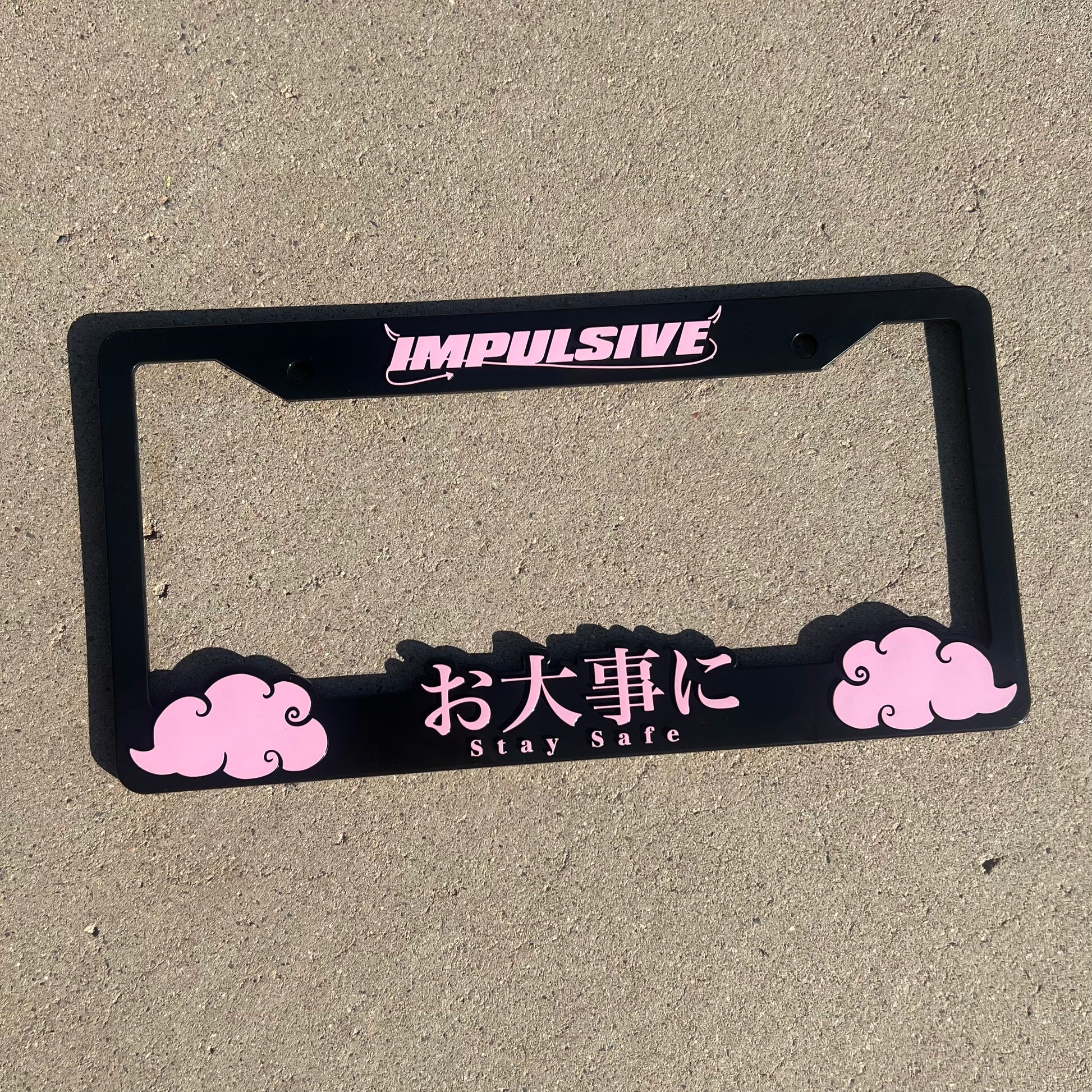 Japanese anime inspired plastic custom License Plate Frame. Top has Impulsive logo and the bottom has japanese characters and english translated to stay safe surrounding with japanese clouds. Asian inspired. Black Frame with Pink lettering.