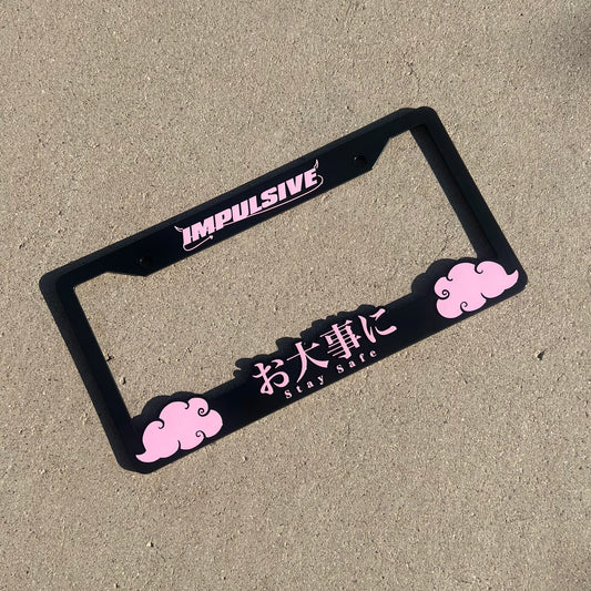 Japanese anime inspired plastic custom License Plate Frame. Top has Impulsive logo and the bottom has japanese characters and english translated to stay safe surrounding with japanese clouds. Asian inspired. Black Frame with Pink lettering.