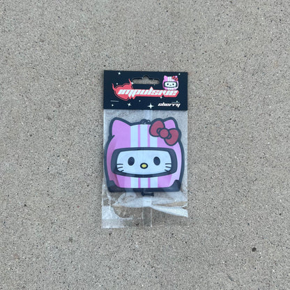 Sanrio Hello kitty racer air freshener hanging from black string. White cat with pink helmet white stripes, red bow anime japanese air freshener. Black Background with white sparkle stars. red y2k impulsive llc logo heart with cherry label cardboard head card.