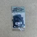 character tuxedo mask air freshener hanging from black string. male japanese anime character wearing black top hat with white glasses and black helmet.  black and white checkered background with black y2k impulsive llc logo and cologne scent label cardboard head card.