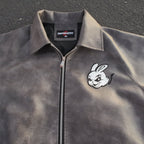 Gray jacket with a logo on a dark surface