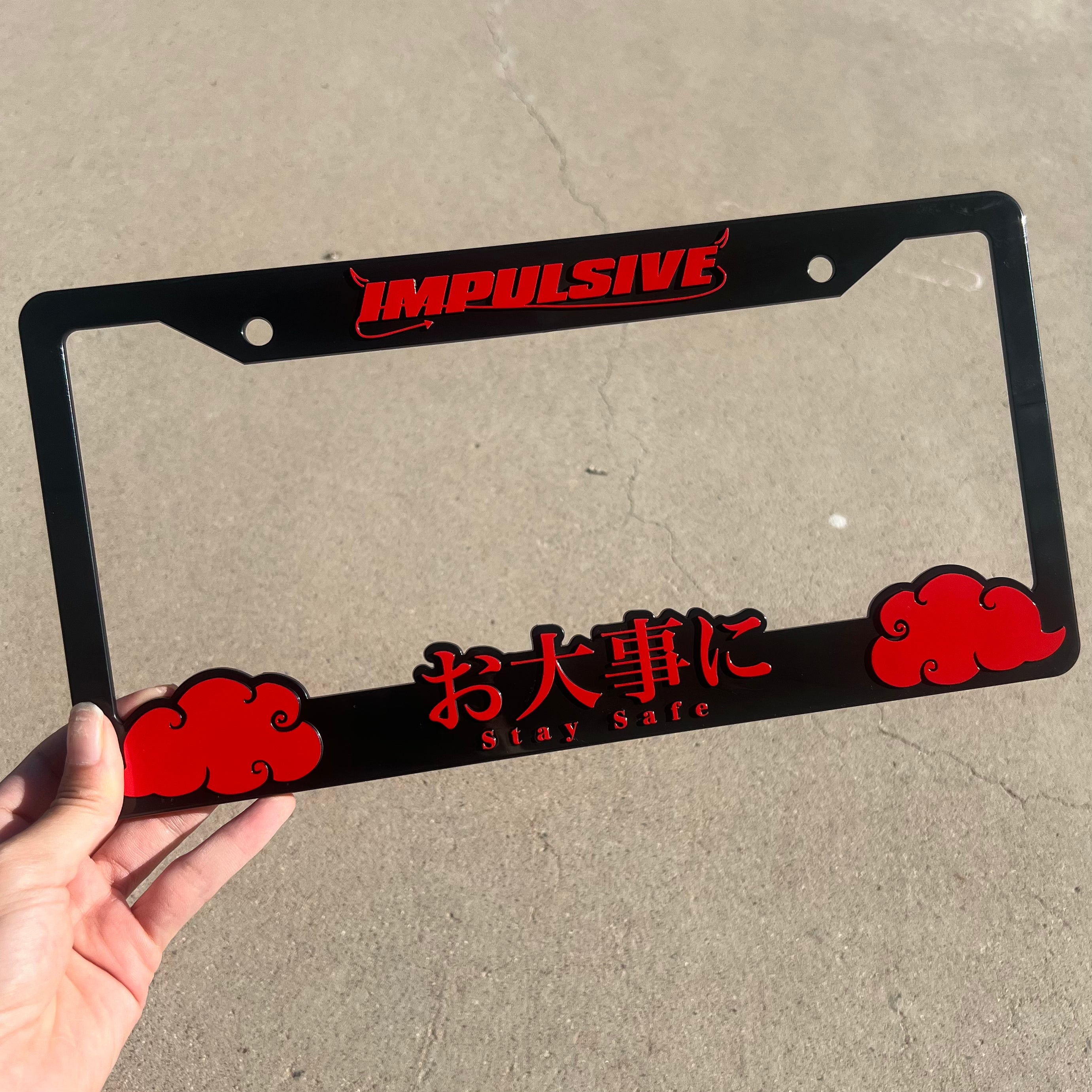 Japanese anime inspired plastic custom License Plate Frame. Top has Impulsive logo and the bottom has japanese characters and english translated to stay safe surrounding with japanese clouds. Asian inspired. Black Frame with Red lettering.
