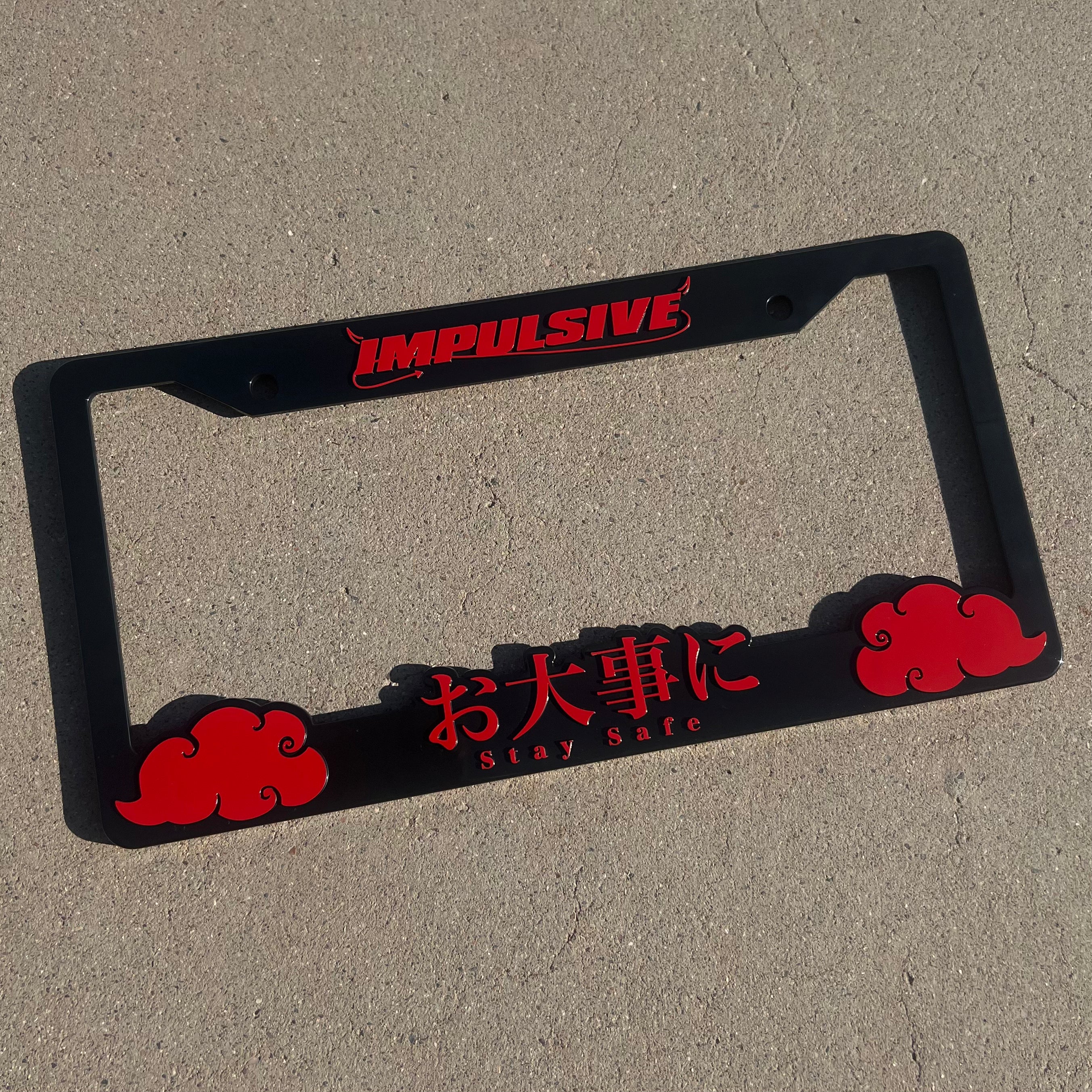 Japanese anime inspired plastic custom License Plate Frame. Top has Impulsive logo and the bottom has japanese characters and english translated to stay safe surrounding with japanese clouds. Asian inspired. Black Frame with Red lettering.