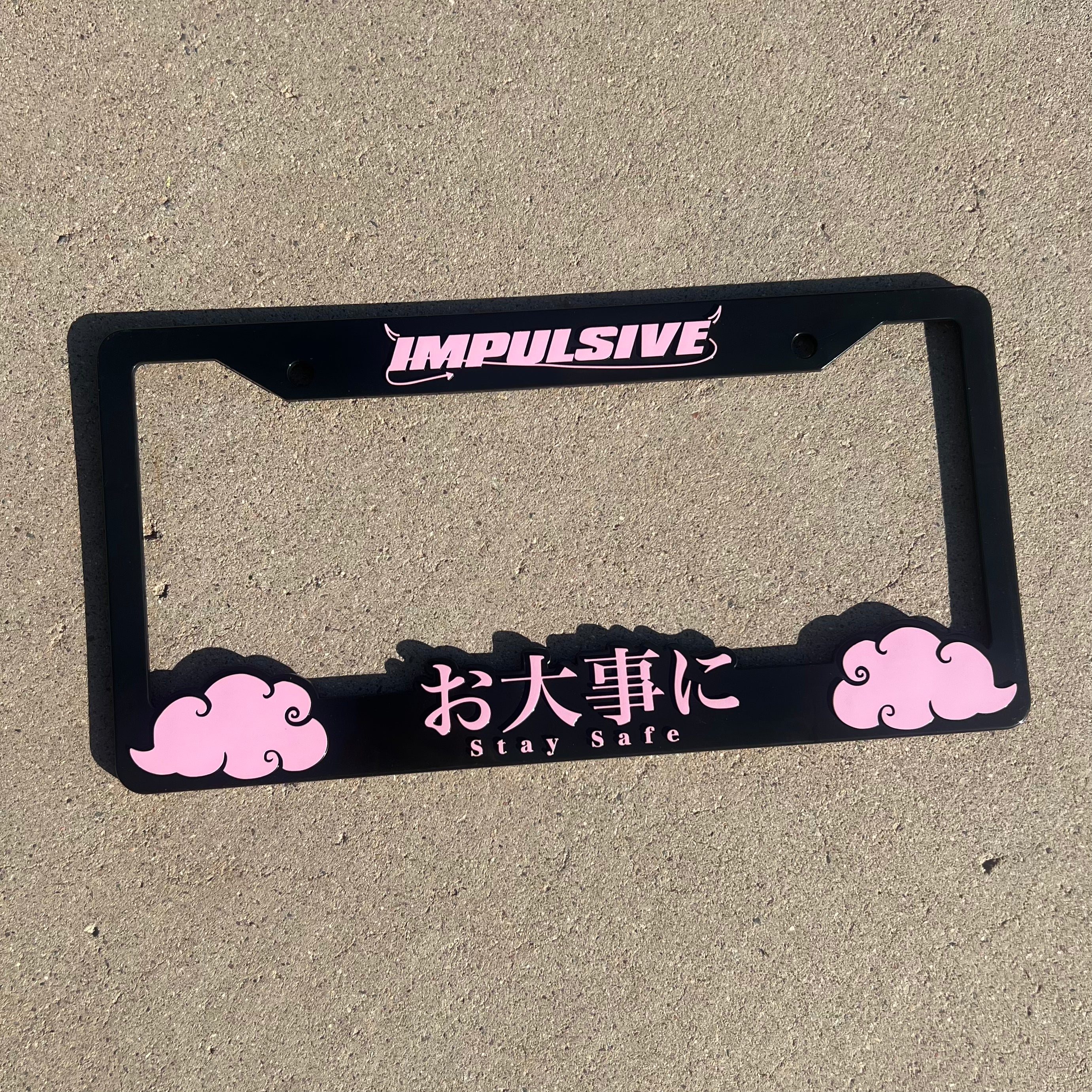 Japanese anime inspired plastic custom License Plate Frame. Top has Impulsive logo and the bottom has japanese characters and english translated to stay safe surrounding with japanese clouds. Asian inspired. Black Frame with Pink lettering.