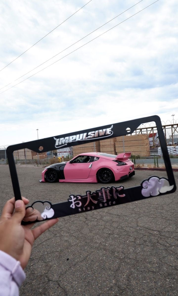 Multiple Japanese anime inspired plastic custom License Plate Frame. Top has Impulsive logo and the bottom has japanese characters and english translated to stay safe surrounding with japanese clouds. Asian inspired. Black Frame with Chrome lettering.