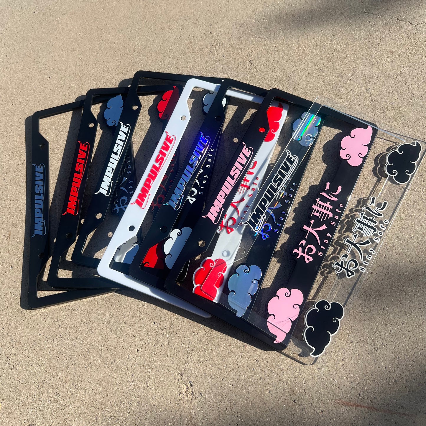 Japanese anime inspired plastic custom License Plate Frame. Top has Impulsive logo and the bottom has japanese characters and english translated to stay safe surrounding with japanese clouds. Asian inspired. Black Frame with Purple lettering.