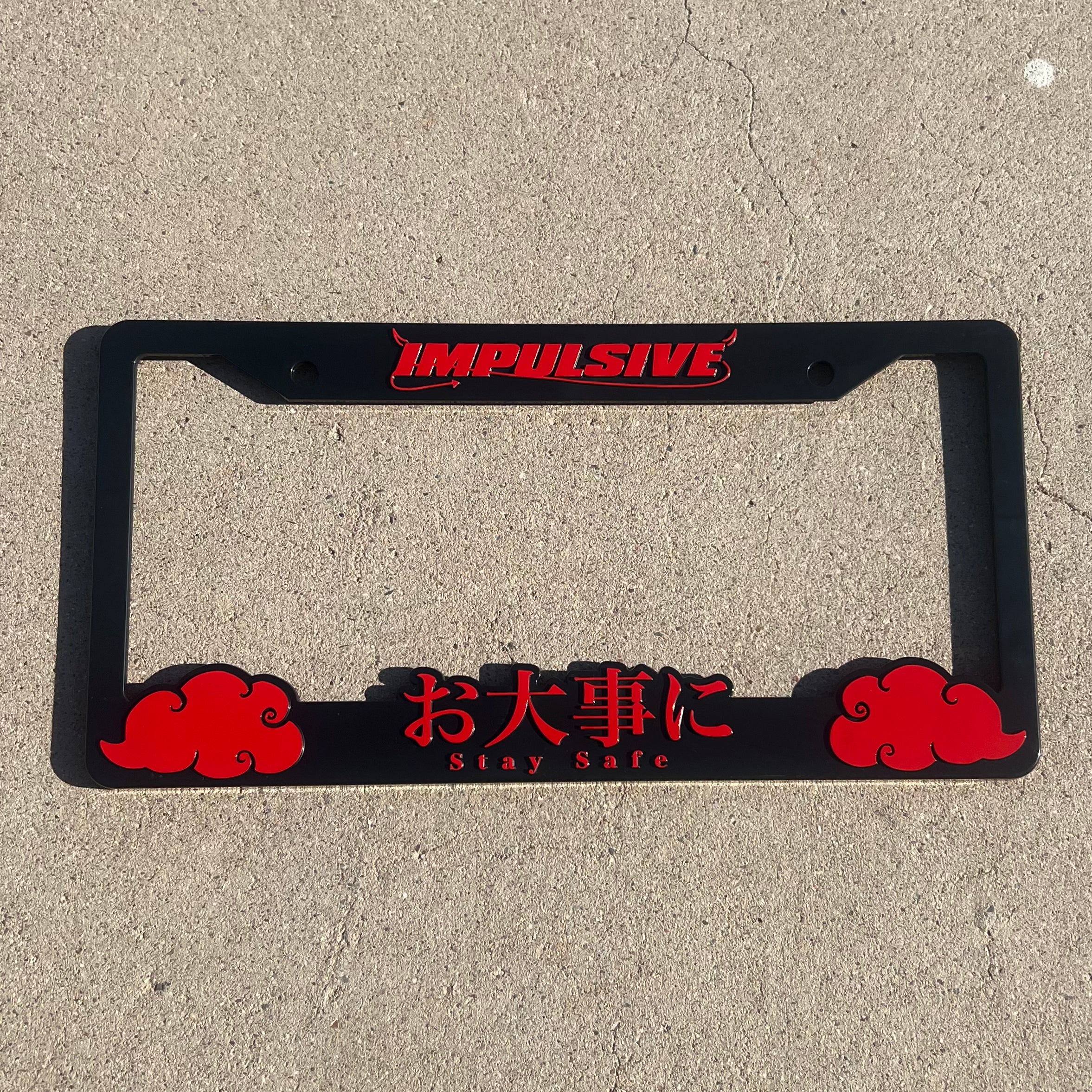 Japanese anime inspired plastic custom License Plate Frame. Top has Impulsive logo and the bottom has japanese characters and english translated to stay safe surrounding with japanese clouds. Asian inspired. Black Frame with Red lettering.