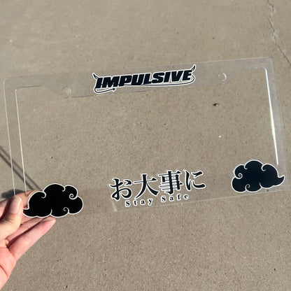 Japanese anime inspired plastic custom License Plate Frame. Top has Impulsive logo and the bottom has japanese characters and english translated to stay safe surrounding with japanese clouds. Asian inspired. Clear Acrylic cut Frame with black and white lettering.