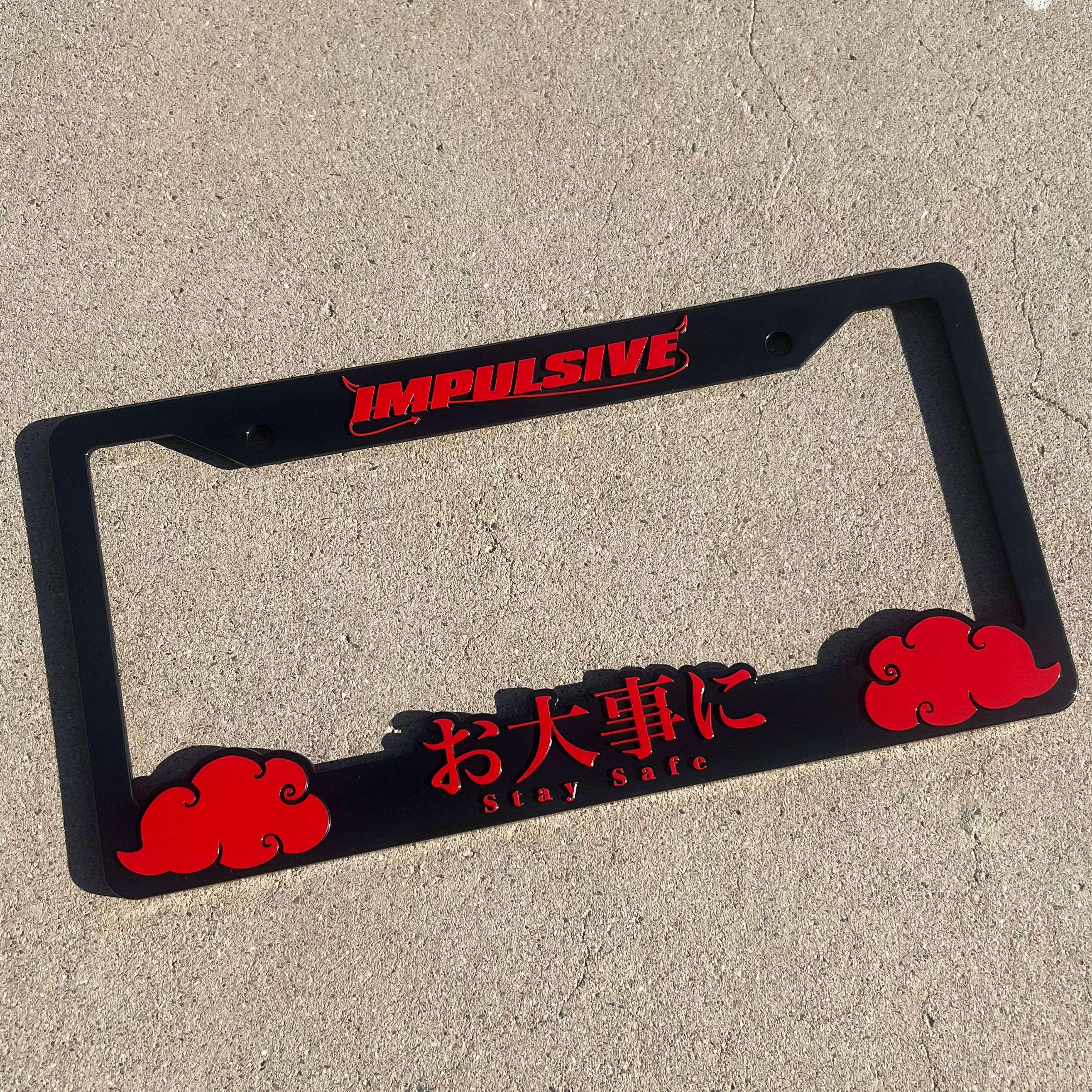 Japanese anime inspired plastic custom License Plate Frame. Top has Impulsive logo and the bottom has japanese characters and english translated to stay safe surrounding with japanese clouds. Asian inspired. Black Frame with Red lettering.