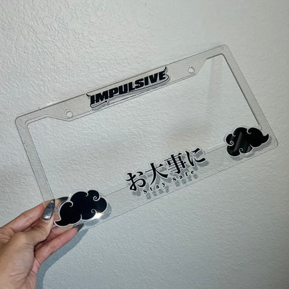 Japanese anime inspired plastic custom License Plate Frame. Top has Impulsive logo and the bottom has japanese characters and english translated to stay safe surrounding with japanese clouds. Asian inspired. Clear Acrylic Frame with Black and white lettering.