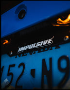 Multiple Japanese anime inspired plastic custom License Plate Frame. Top has Impulsive logo and the bottom has japanese characters and english translated to stay safe surrounding with japanese clouds. Black frame with white lettering