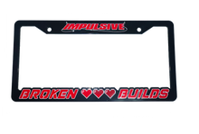 Load image into Gallery viewer, Anime Retro Pixel Arcade Video Game inspired plastic custom License Plate Frame. Top has Impulsive logo and the bottom has words &quot;Broken Build&quot; with 3 pixel damaged and full health pixel hearts. Asian inspired. Black Frame with Red and white outlined lettering.
