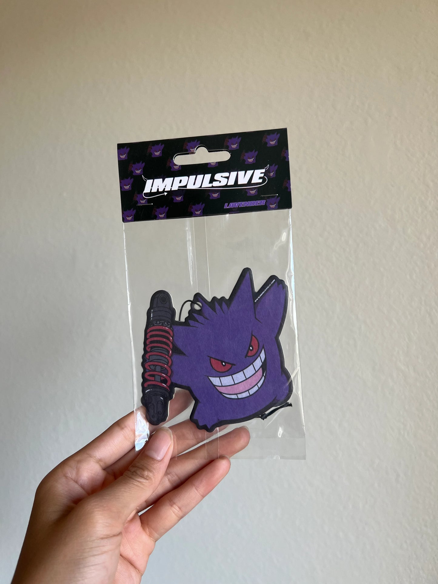 Pokemon Gengar Purple Monster holding Coilover car suspension hanging from black string air freshener.