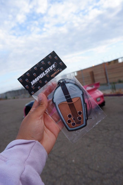 Brown sugar Milk tea boba hanging from black string air freshener.